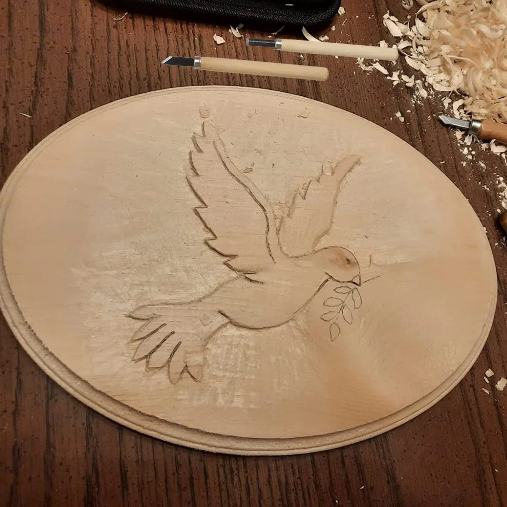 A light-colored wood carving shows a detailed silhouette of a dove with olive branches carved into it.