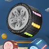 A black and gray 3D rotating slide puzzle cube with a large wheel and colorful protrusions is shown against a blue sky backgr