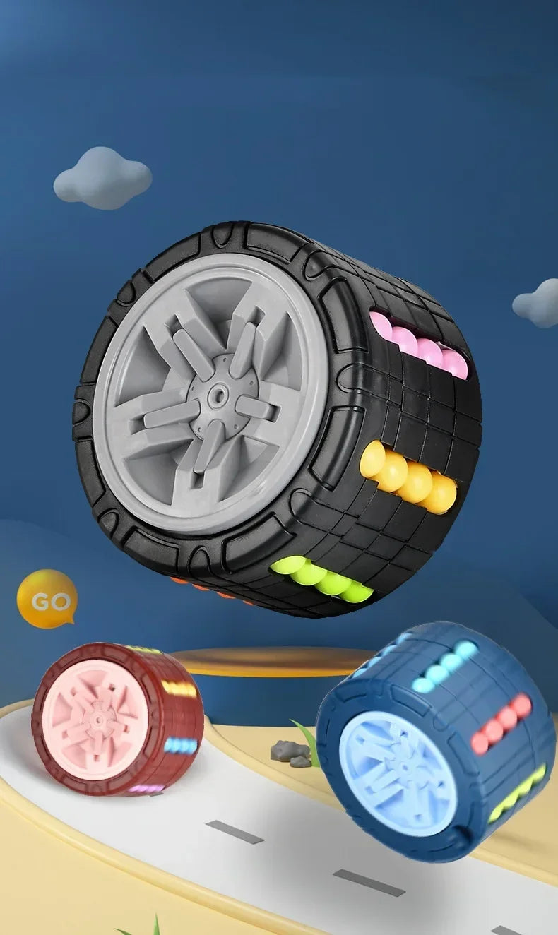 A black and gray 3D rotating slide puzzle cube with a large wheel and colorful protrusions is shown against a blue sky backgr