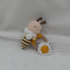 A handcrafted wooden baby rattle and teether ring shaped like a bee with a white beard and a flower.