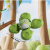 A green spinning bath toy set shaped like a frog for toddlers is shown against a light blue sky background.