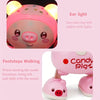 A pink interactive dancing pig toy with lights and music, shown in close-up and full view.