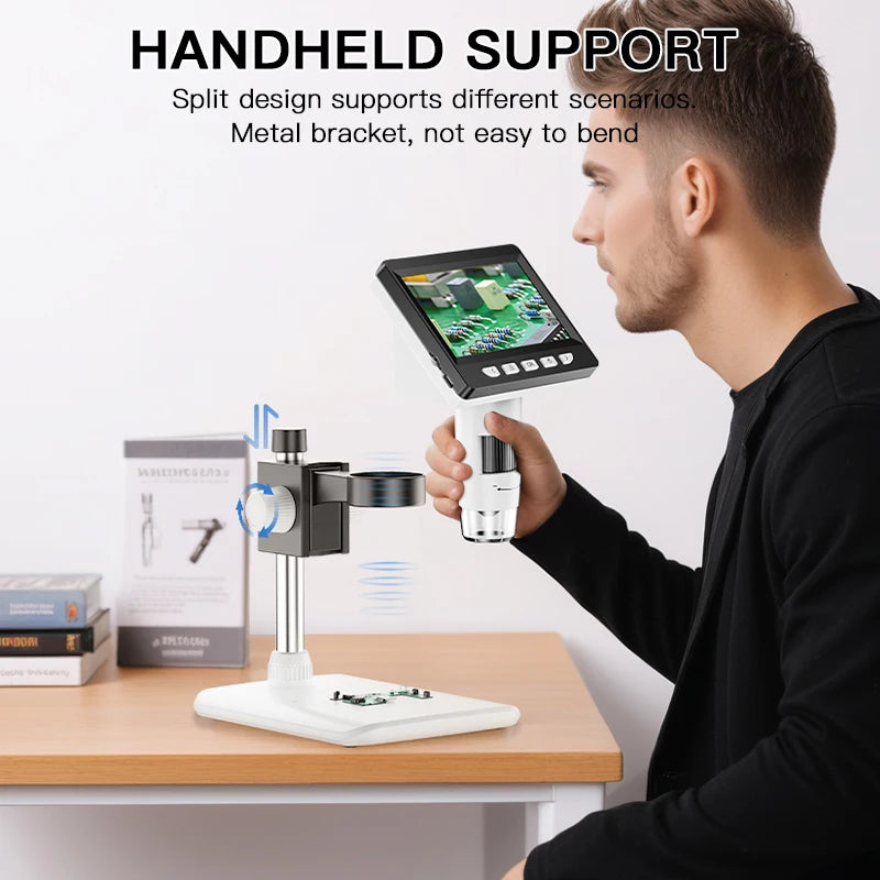 A man is holding a handheld digital microscope with a split design and metal bracket on a wooden table.