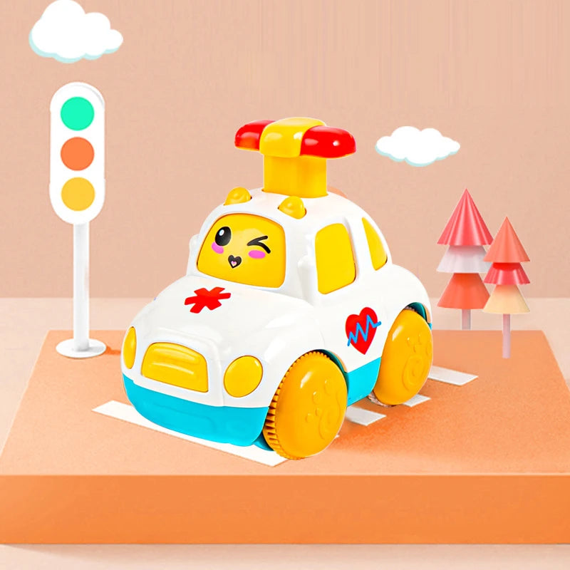 A yellow and white light-up gear car toy for toddlers is displayed on an orange surface next to a traffic light.