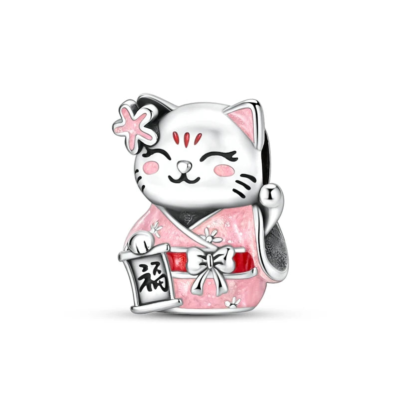 A silver heart charm bead featuring a cute cat design with pink accents and a decorative bow.