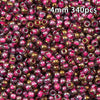 A close-up view of 340 golden gradient glass beads with pink accents.