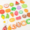 A collection of wooden salad pretend play food items including fruits and vegetables like watermelon, pumpkin, carrots, and c