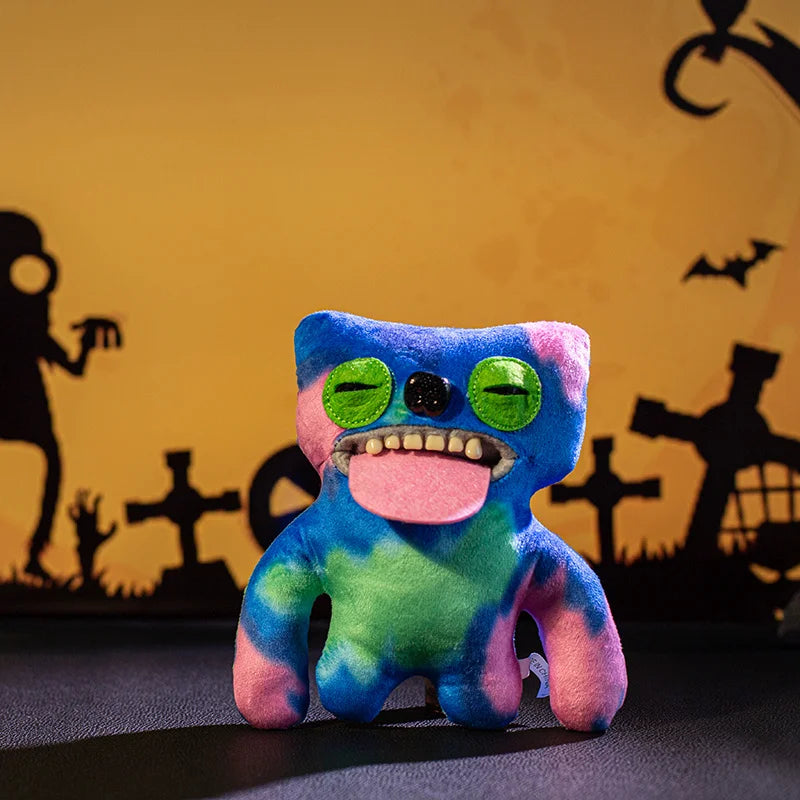 A colorful plush monster doll with big teeth and bright green eyes against a dark background.