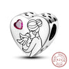 A sterling silver heart charm bead featuring a silhouette of a woman with flowing hair and a pink gemstone inset.