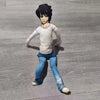 A dark-haired anime-style plush doll resembling L Lawliet from Death Note, wearing a light gray shirt and blue jeans.