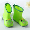 A pair of bright lime green rain boots for children with green trim.