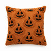 A brown knitted pillow cover featuring a repeating pattern of carved jack-o'-lantern faces.