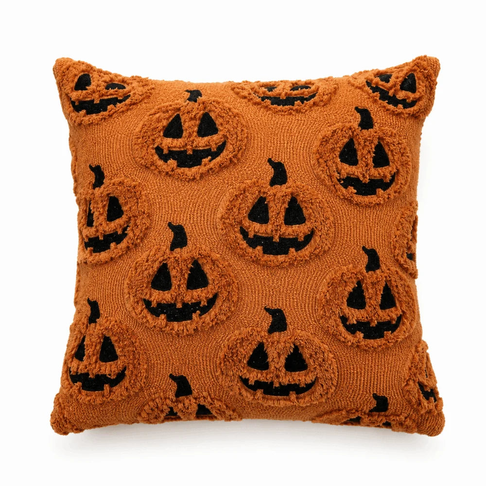 A brown knitted pillow cover featuring a repeating pattern of carved jack-o'-lantern faces.