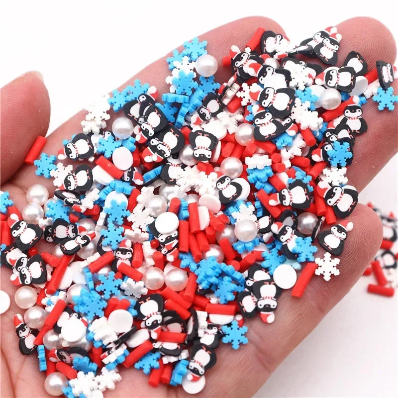 A pile of polymer clay slices in red, white, and blue colors with black designs is held in a hand.
