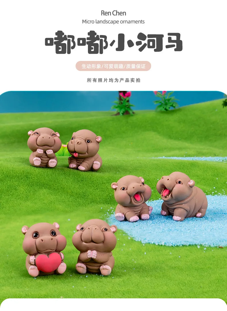 A set of small, cute resin hippo figurines in various poses and colors displayed on a green landscape background.