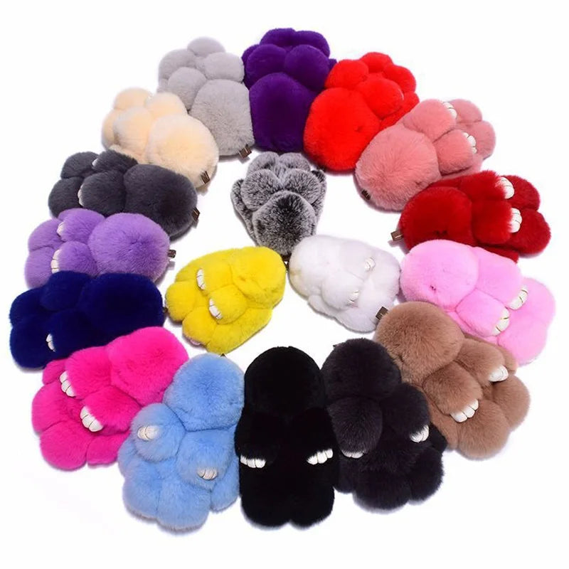A collection of colorful plush bunny keychains in various shades including pink, purple, red, yellow, and black.