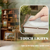 A close-up of a DIY wooden book nook kit featuring Monet's Studio miniature, showing a lighted display inside a dust cover.
