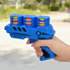 A hand holds a blue foam flying disc launcher toy with colorful discs, outdoors.