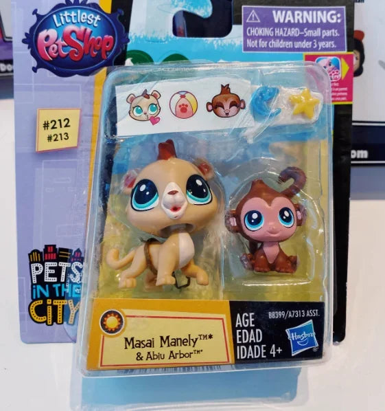 A plastic package containing three small animal figures, including a lion cub and an elephant, for sale in a PetShop box.