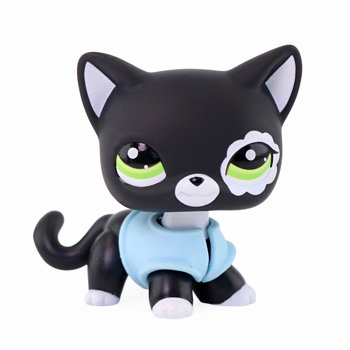 A black cat miniature figure with white markings and a light blue collar.