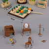 A collection of 1:12 scale dollhouse furniture including a kitchen set, living room sofa, bedroom pieces, and decorative item