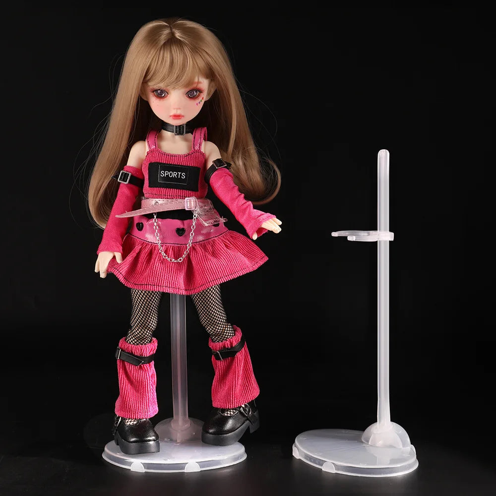 A pink-clad doll figure wearing a sports uniform is displayed on a clear transparent stand.