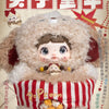 A plush doll resembling a bear or animal head is shown, packaged with red and white striped fabric, featuring Japanese text.