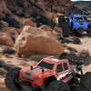 An orange and black off-road RC car is shown driving over rocky terrain.