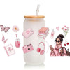 A clear glass cup wrapped in pink and floral themed silicone cups, featuring various makeup and stationery items.