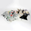 A sheet of artistic DTF transfer film featuring layered, stylized human faces and abstract designs.