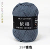 A ball of gray milk cotton yarn labeled 39# in a dark background.