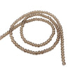 A string of light brown faceted crystal beads used for jewelry making.