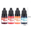 A set of five glass dropper bottles containing liquid candle dye in red, orange red, orange yellow, and sky blue colors.