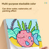 A close-up view of a stackable silky crayon drawing a colorful fish on paper.