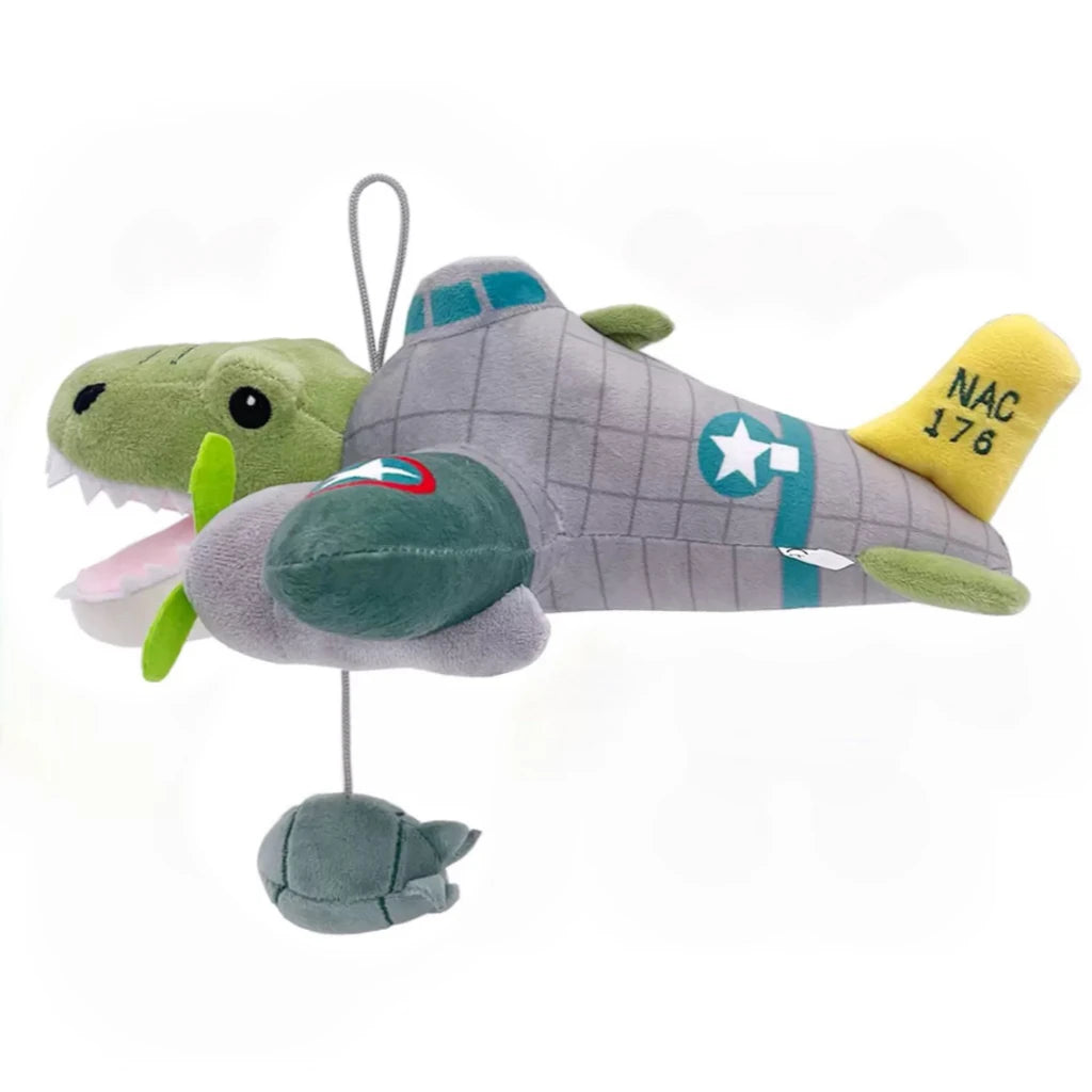 A gray shark plush toy with green accents and a yellow tag displaying NAC 176.