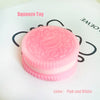 A pink and white silicone squeeze toy or stress relief fidget with a textured surface.