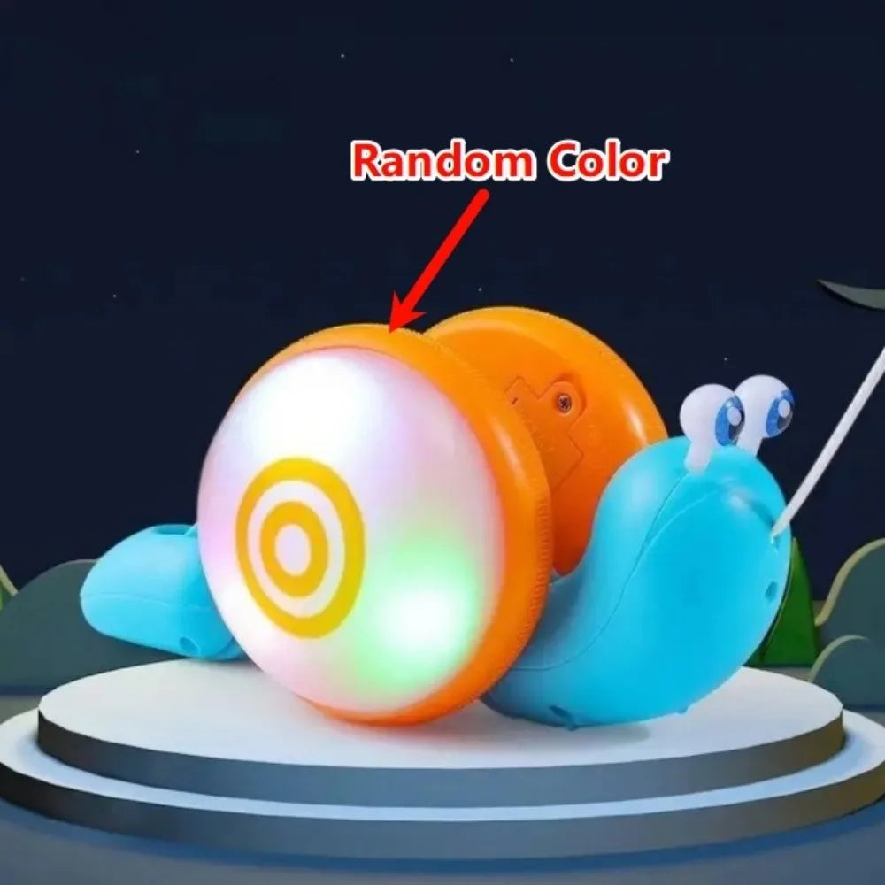 A musical pull-along snail toy with a random color light shining on the front, displayed on a round platform.