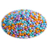 A pile of colorful sensory play sand for kids in various shades of blue, purple, orange, and white.