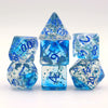 A set of crystal-style polyhedral dice in shades of blue and clear, displayed together.