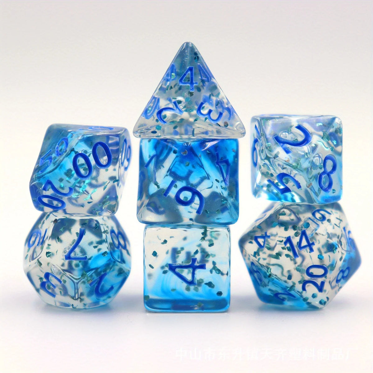 A set of crystal-style polyhedral dice in shades of blue and clear, displayed together.
