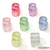 A collection of colorful, translucent acrylic alphabet beads in pink, purple, and green shades.
