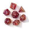 A set of seven polyhedral acrylic dice in various colors and shapes scattered on a white surface.