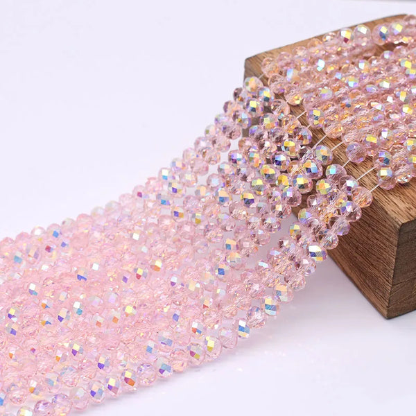 Pink crystal glass beads strung on a wooden bracelet for jewelry making