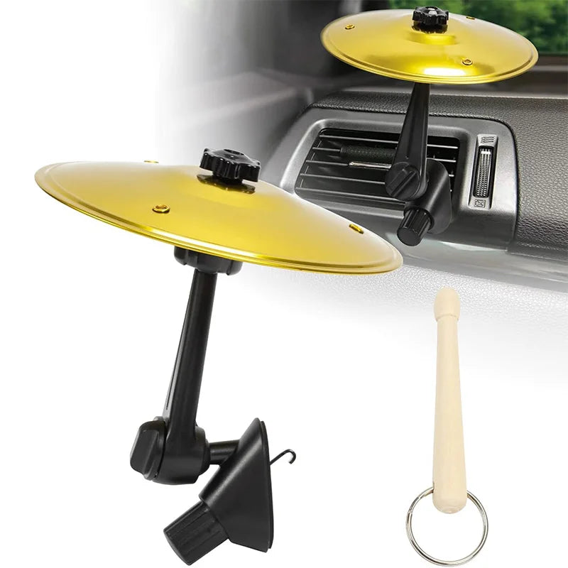 A gold-colored clip-on mini alloy cymbal ornament is shown mounted on a black air vent with a white decorative piece.