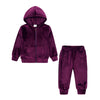 A deep purple velvet kids tracksuit set featuring a hooded zipper jacket and matching pants.