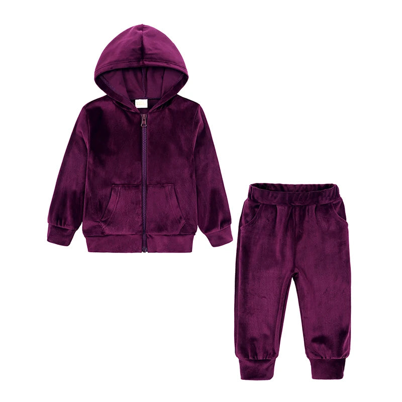 A deep purple velvet kids tracksuit set featuring a hooded zipper jacket and matching pants.