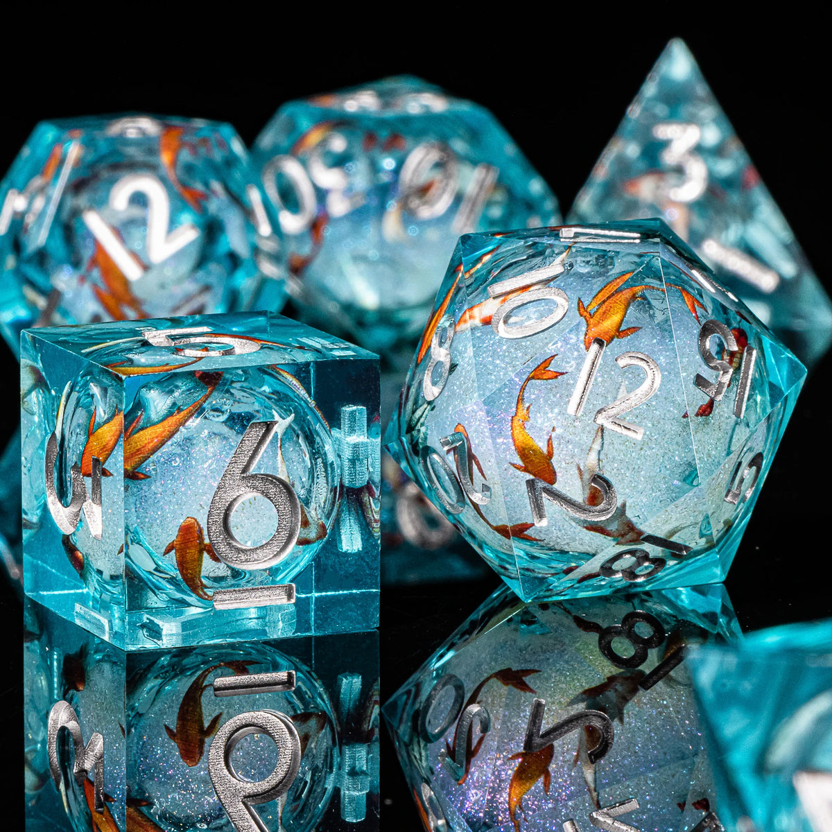 A close-up of a set of translucent blue liquid core dice, including a d6 and a triangular die, resting on a dark surface.