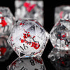A close-up of a translucent, faceted die with red markings, reflecting on a dark surface.