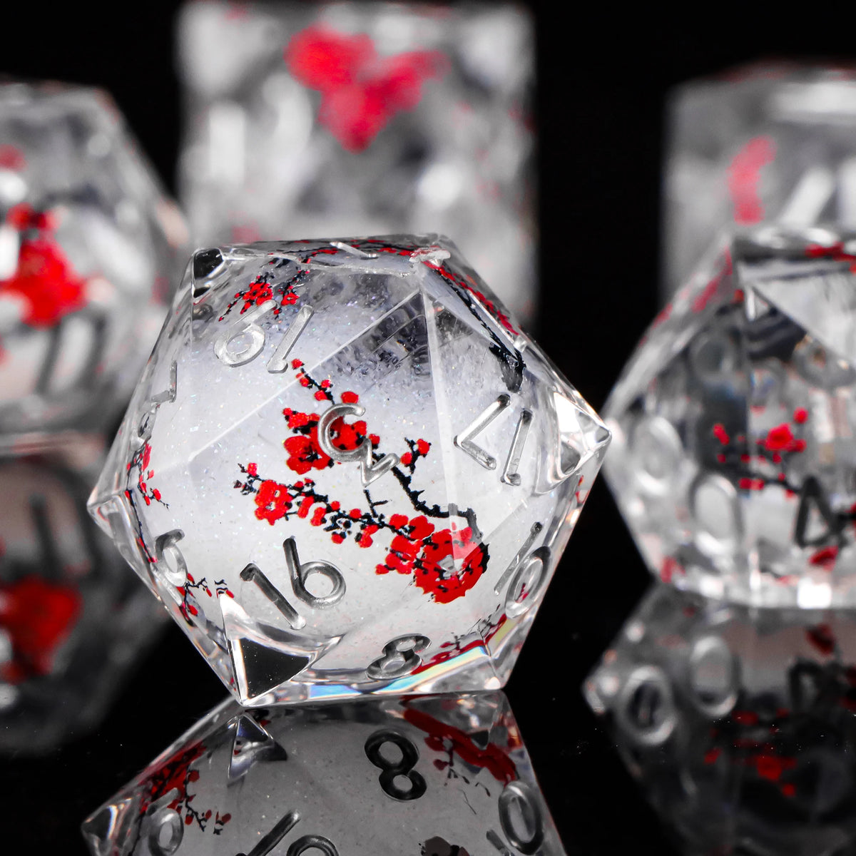 A close-up of a translucent, faceted die with red markings, reflecting on a dark surface.