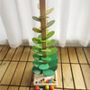 A wooden sensory music tree structure with green leaves and a marble run is displayed on a light wooden floor.